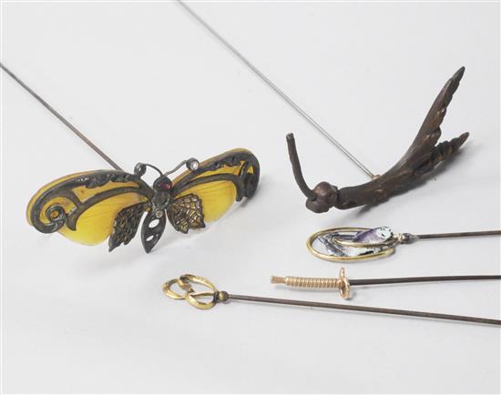 Five assorted hatpins including enamel, horn and French 18ct gold.